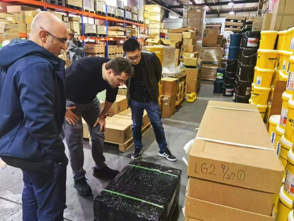 Visitors inspecting parts in the warehouse